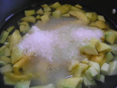 Add peeled & chopped raw mango pieces, sugar and water